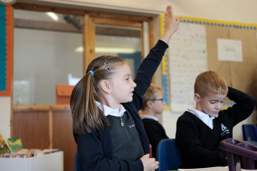 Image of pupil with hand up