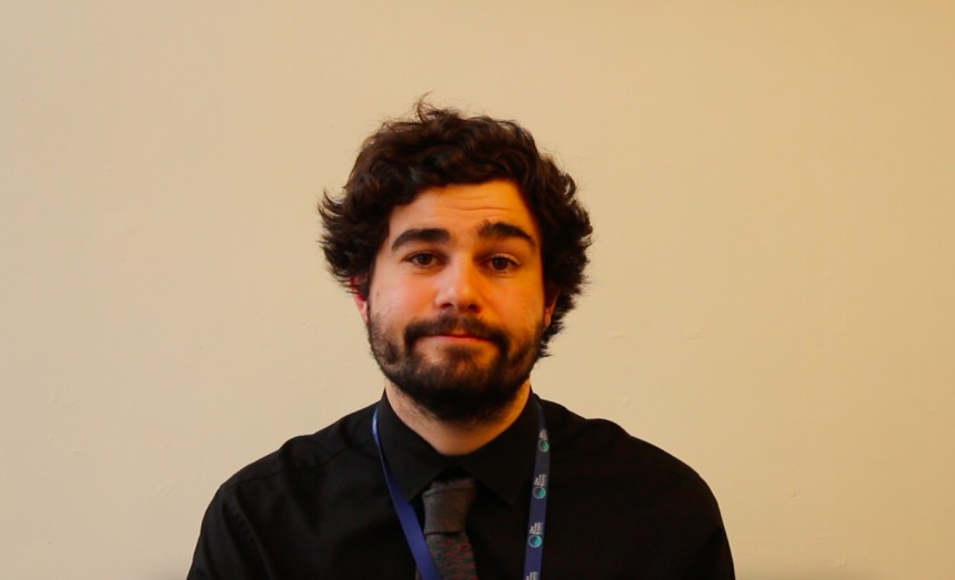 Image of trainee teacher Josh sat at his desk writing