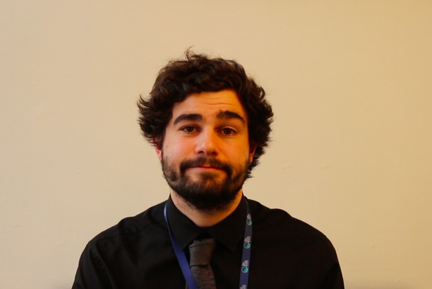 Image of trainee teacher Josh sat at his desk writing