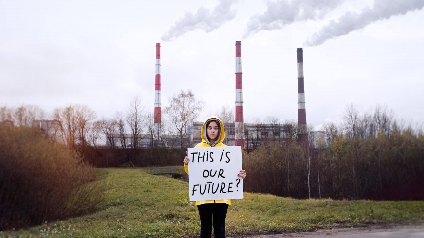 Female child holding a sign saying 'this is our future'