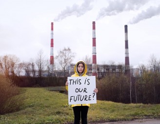 Female child holding a sign saying 'this is our future'