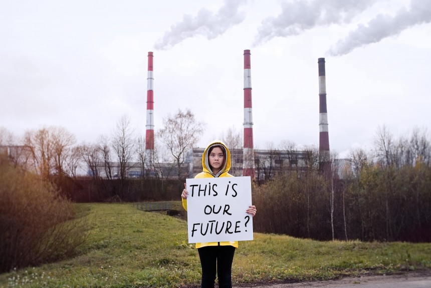 Female child holding a sign saying 'this is our future'